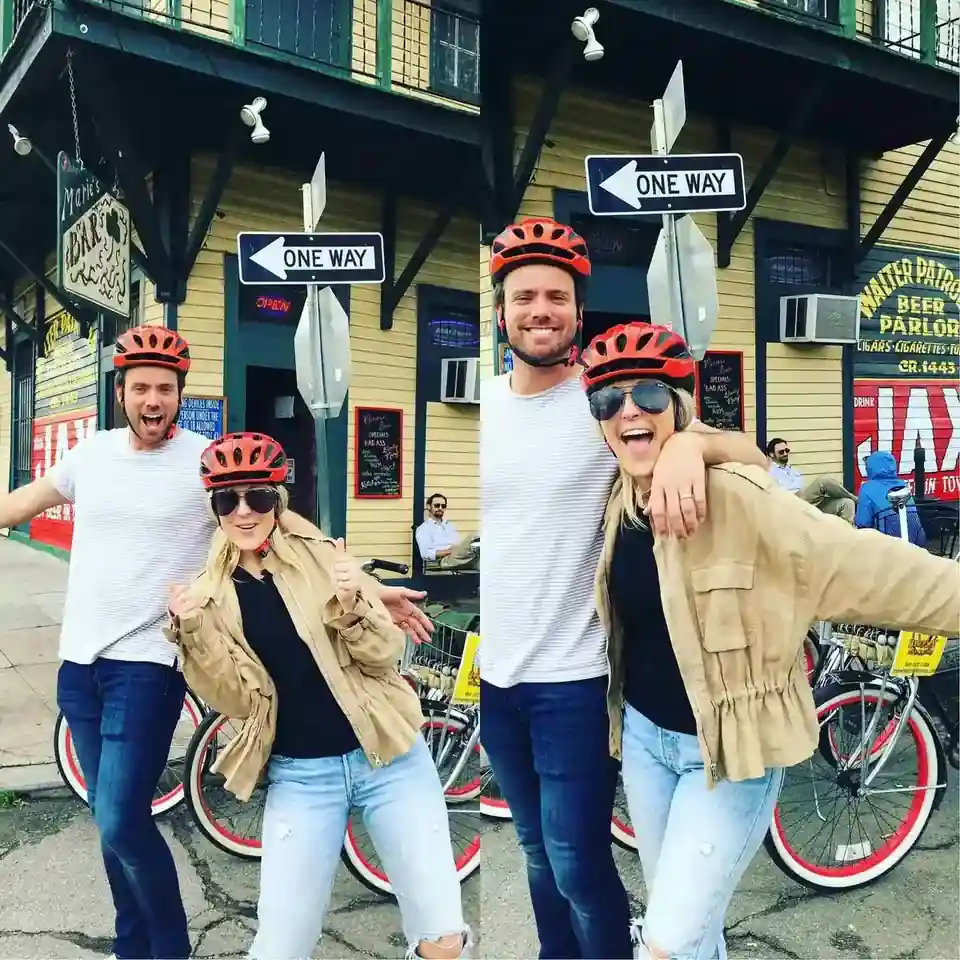 Happy riders with helmets on E-Bikes and cruisers exploring the historic French Quarter in New Orleans near Burgundy Street