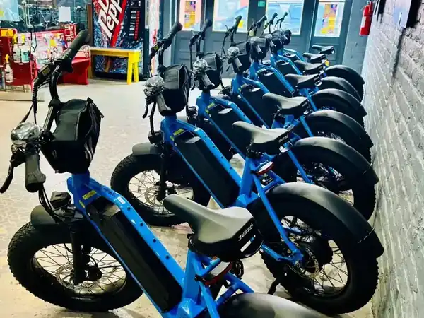 Blue electric fat-tire E-Bikes available for rent at Bike Rental New Orleans French Quarter shop on Burgundy Street